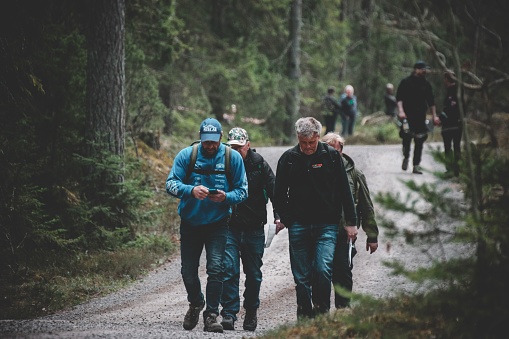 Nybro, Sweden – April 30, 2022: A view of people walking in the forest during Rallycross in  Sweden, Nybro