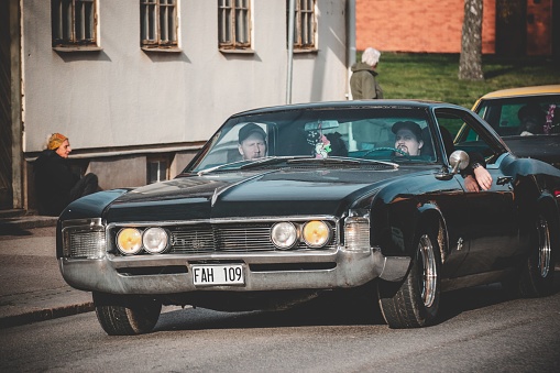 Nybro, Sweden – April 30, 2022: A black retro car at an event with cruising old cars in a small town in Sweden.