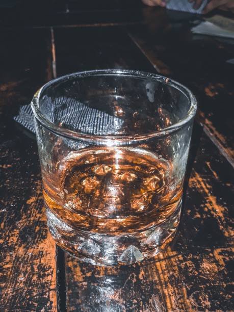 Vertical shot of a cup of water on the wooden background