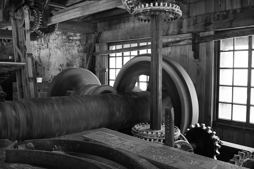 A grayscale of the steam engine inside wall and windows background
