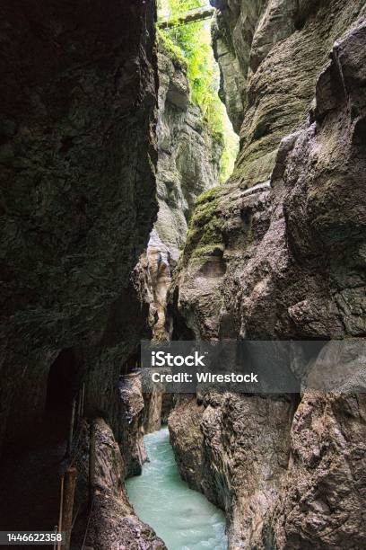 Vertical Of The Partnachklamm Canyon And A Thin River Flowing In The Middle Germany Stock Photo - Download Image Now