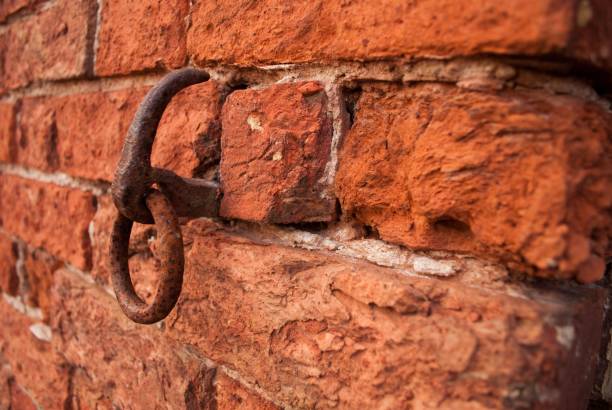istock Closeup of a rusty metal ring on a red brick wall 1446622622