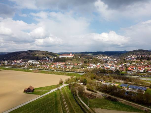 istock Aerial of fields an a town under a blue cloudy sky. 1446627559