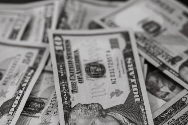 istock Grayscale closeup of dollar banknotes. 1446627627