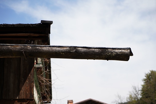 A selective focus shot of a wooden log on a house