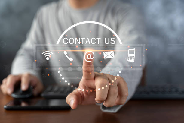 istock Contact us or Customer support hotline people connect. Businessman using a laptop and touching on virtual screen contact icons 1446629251