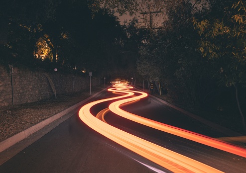 A long exposure shot of the light trails on the road at night