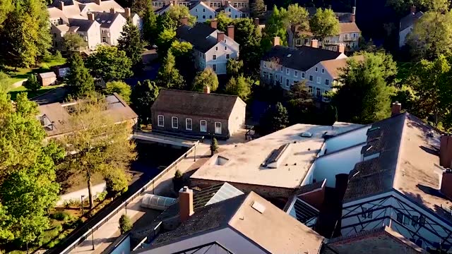 drone flying over quaint new england style homes.