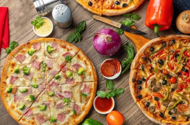 istock Top view of different pizzas on a wooden surface with different ingredients 1446630642