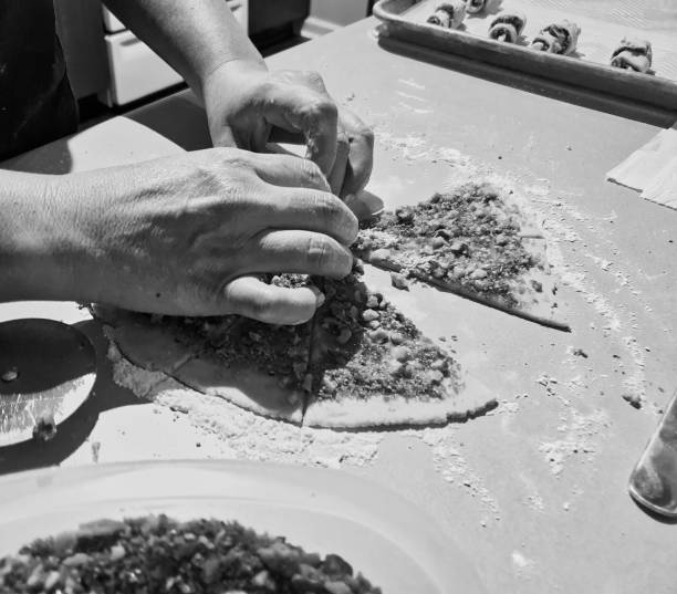 istock Grayscale of hands making dessert from a dough 1446632201