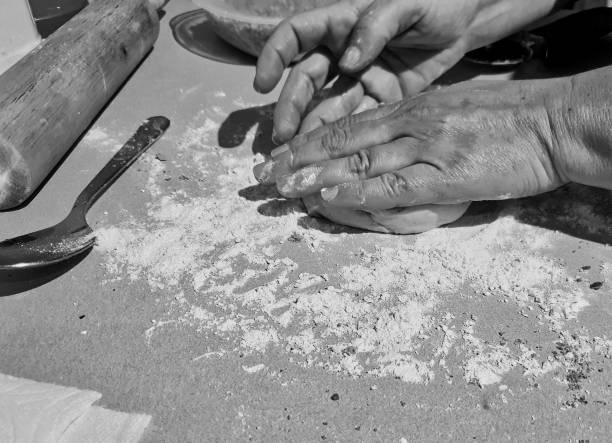 istock Grayscale of hands making dessert from a dough 1446632206
