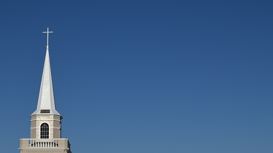 A closeup of a white Palma Sola Presbyterian church dome against clear sunlit sky background