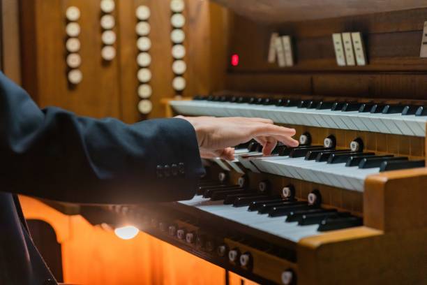 istock Closeup shot of a man playing an organ. 1446633708