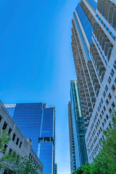 istock Looking up at apartments with modern geometric architecture against blue sky 1446634202