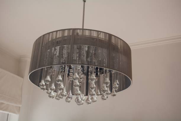 istock Low angle shot of a decorative crystal chandelier hanging from a white ceiling 1446635955