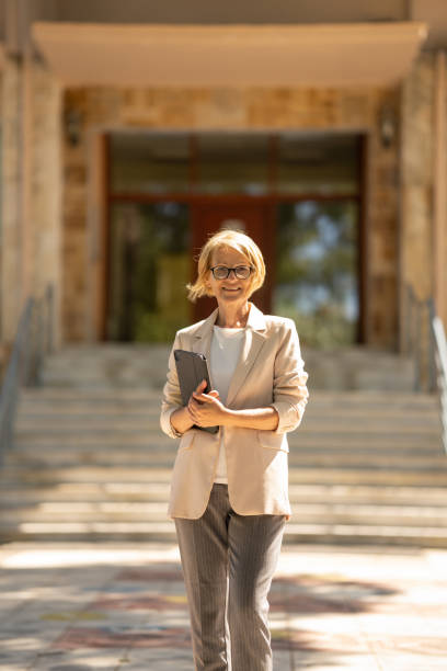 istock Real estate agent standing outside building 1446636559