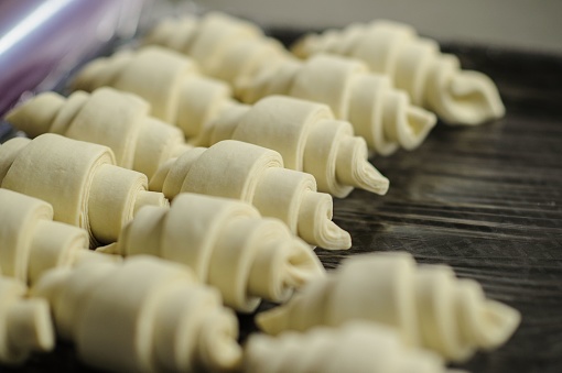 A closeup of making croissants in a bakery