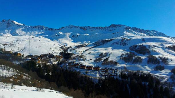 istock Scenic view of snowy mountains under a clear cloudless sky 1446637148