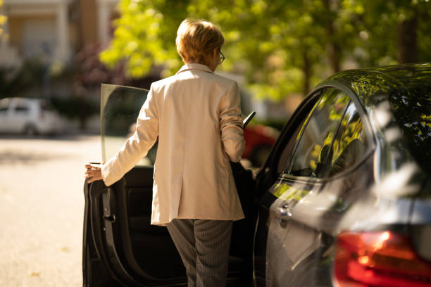 Business woman getting into car after work