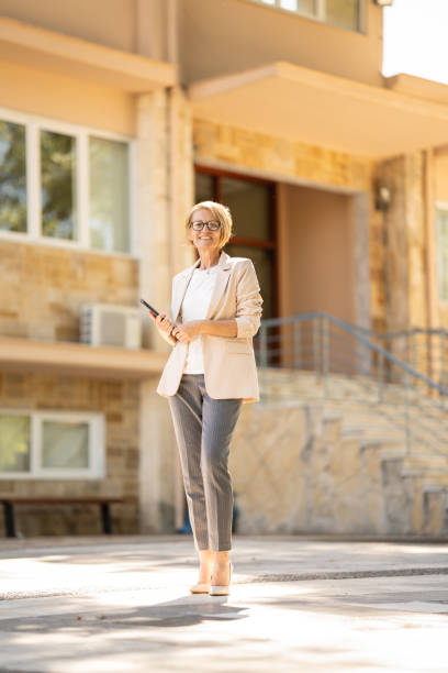 Full length of confident Real Estate Agent outdoors stock photo
