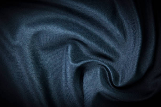 istock A dark modern satin texture wallpaper and background. Luxury smooth blue silk and satin fabric concepts. 1446638546
