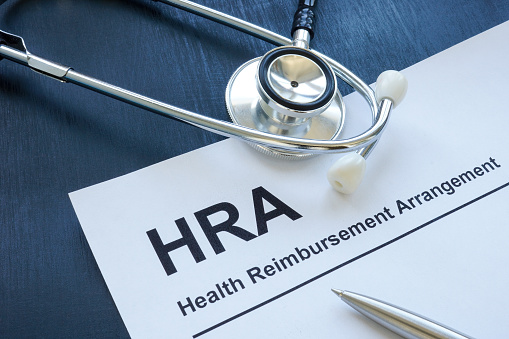 HRA health reimbursement arrangement application and a stethoscope.