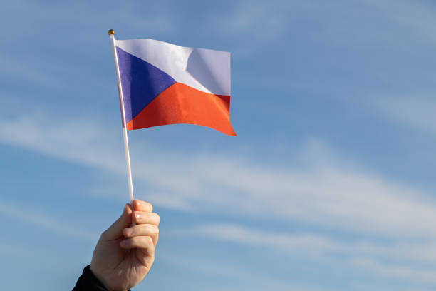 istock Czech flag in hand flutters in the wind against the sky 1446638805