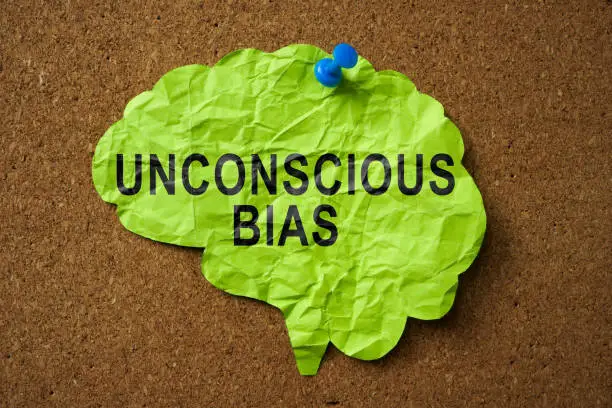 A Brain made of paper with the inscription Unconscious Bias pinned to the board.