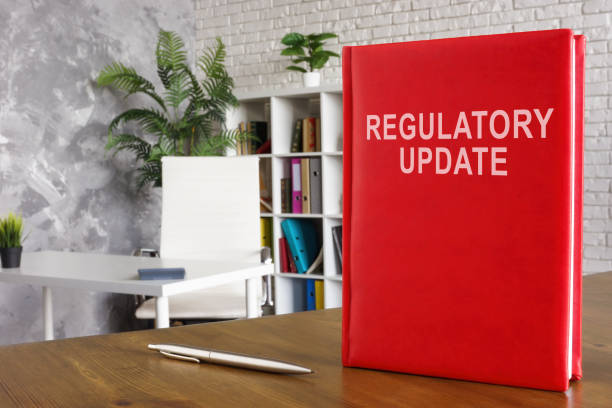 Regulatory update book on the wooden surface. A Regulatory update book on the wooden surface. Regulatory Reforms stock pictures, royalty-free photos & images