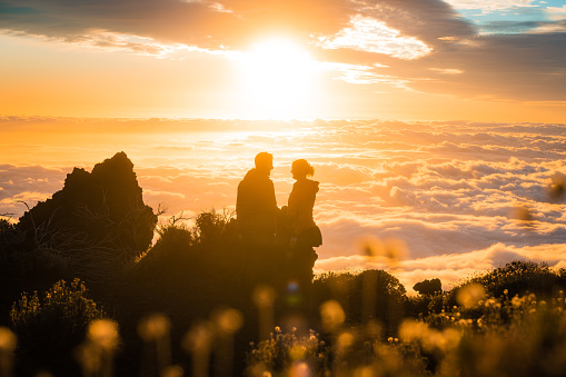 Young couple watches the sunset from Teide national park, Tenerife.