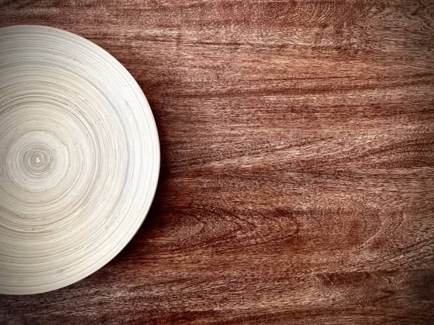 istock wooden plate with concentric circles texture on a dark brown wooden table 1446645285