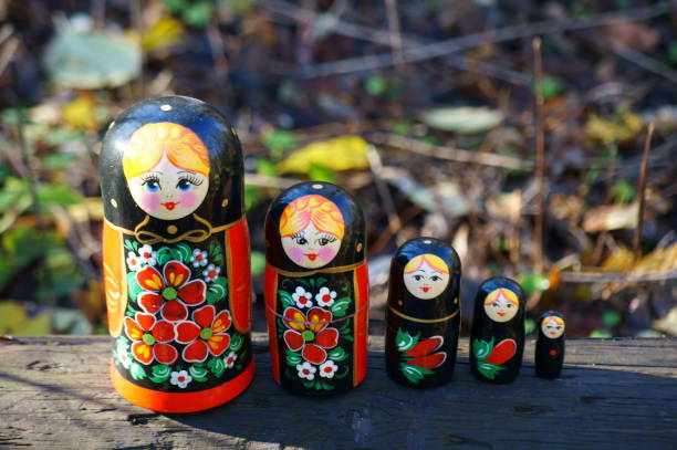 istock A group of nesting dolls decorated with patterns on the background of trees in a grove. 1446648122
