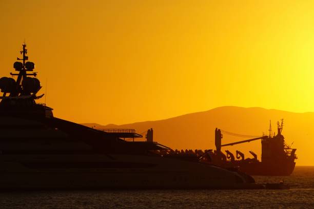 A big new modern yacht at sunset.