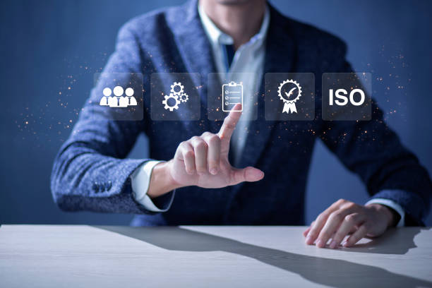 istock ISO Certification of standards quality control assurance business technology concept. Businessman touching virtual screen iso certification icon to guarantee. 1446651890