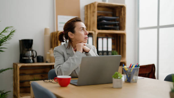 istock Middle age hispanic woman business worker working at office 1446654670