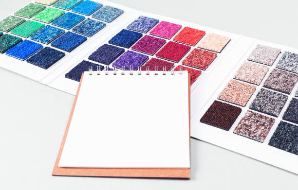 istock Multicolored carpet swatches book and notepad on blue 1446655506