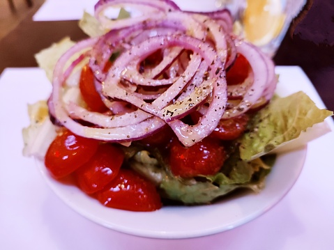 Greek salad with onion and cherry tomatoes serving at glasgow scotland england uk