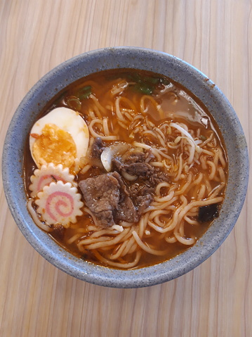 Delicious spicy ramen on the wood table