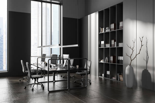 istock Grey business interior with coworking area and pc computers, shelf and window 1446661228