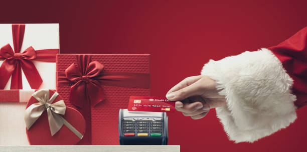 istock Santa Claus paying with a credit card 1446670322