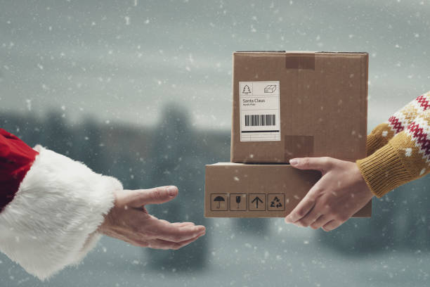 istock Santa Claus receiving boxes hands close up 1446670456