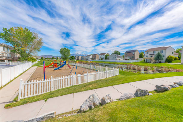 Small playground with white picket fence in community at Utah