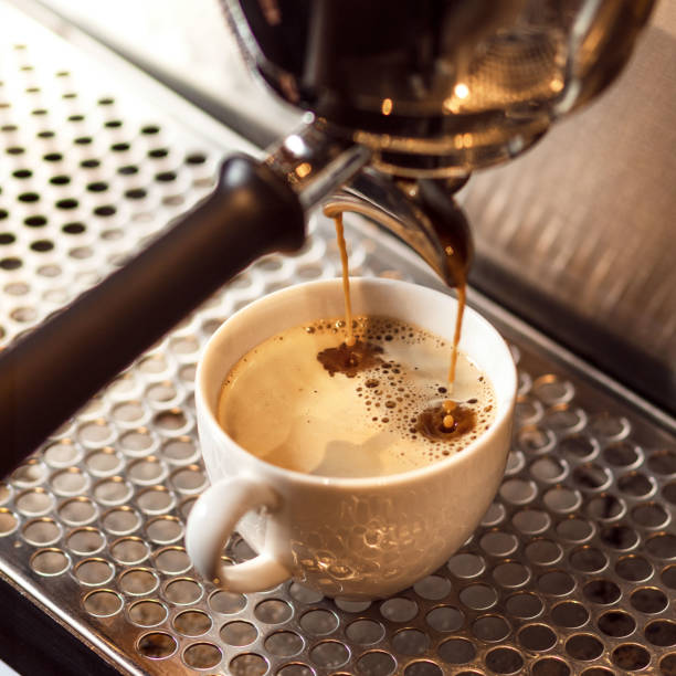 istock Espresso poruing from coffee machine at cafe restaurant 1446674955