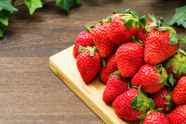 istock Fresh strawberry fruits on wooden table 1446678201