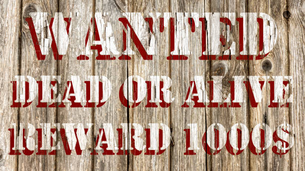 istock Wanted dead or alive poster on wood chipped paint effect graphic design 1446679240