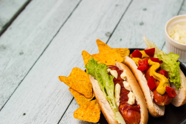 istock Hot dogs with different toppings on a table 1446680798