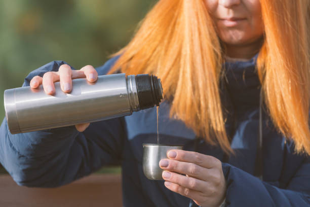 istock Drinking hot tea from thermos outdoors 1446680848