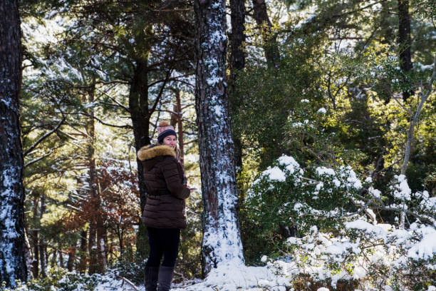 istock Woman Looking Back With Mobile Phone In Forest 1446681693