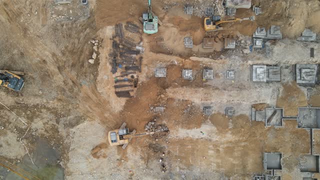 Machines and workers are working on the loess construction site