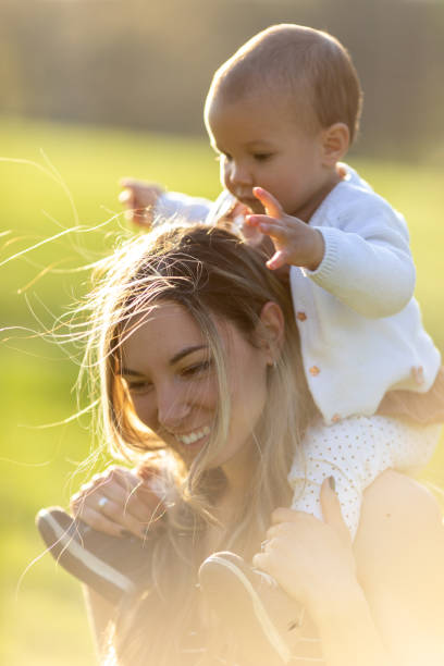 istock Young mother enjoying with her baby outdoors at sunset 1446688507